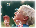 boy playing with bubbles